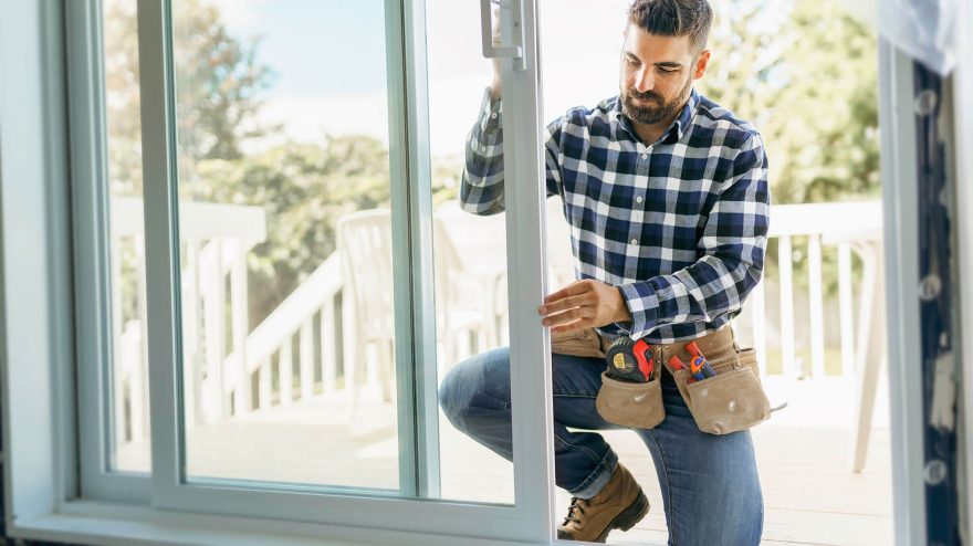 Man adjusting a sliding glass door