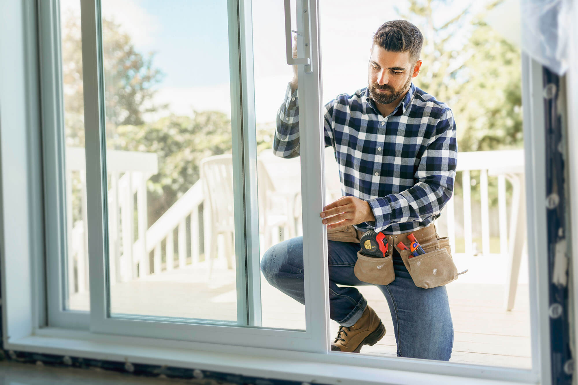 Man adjusting a sliding glass door