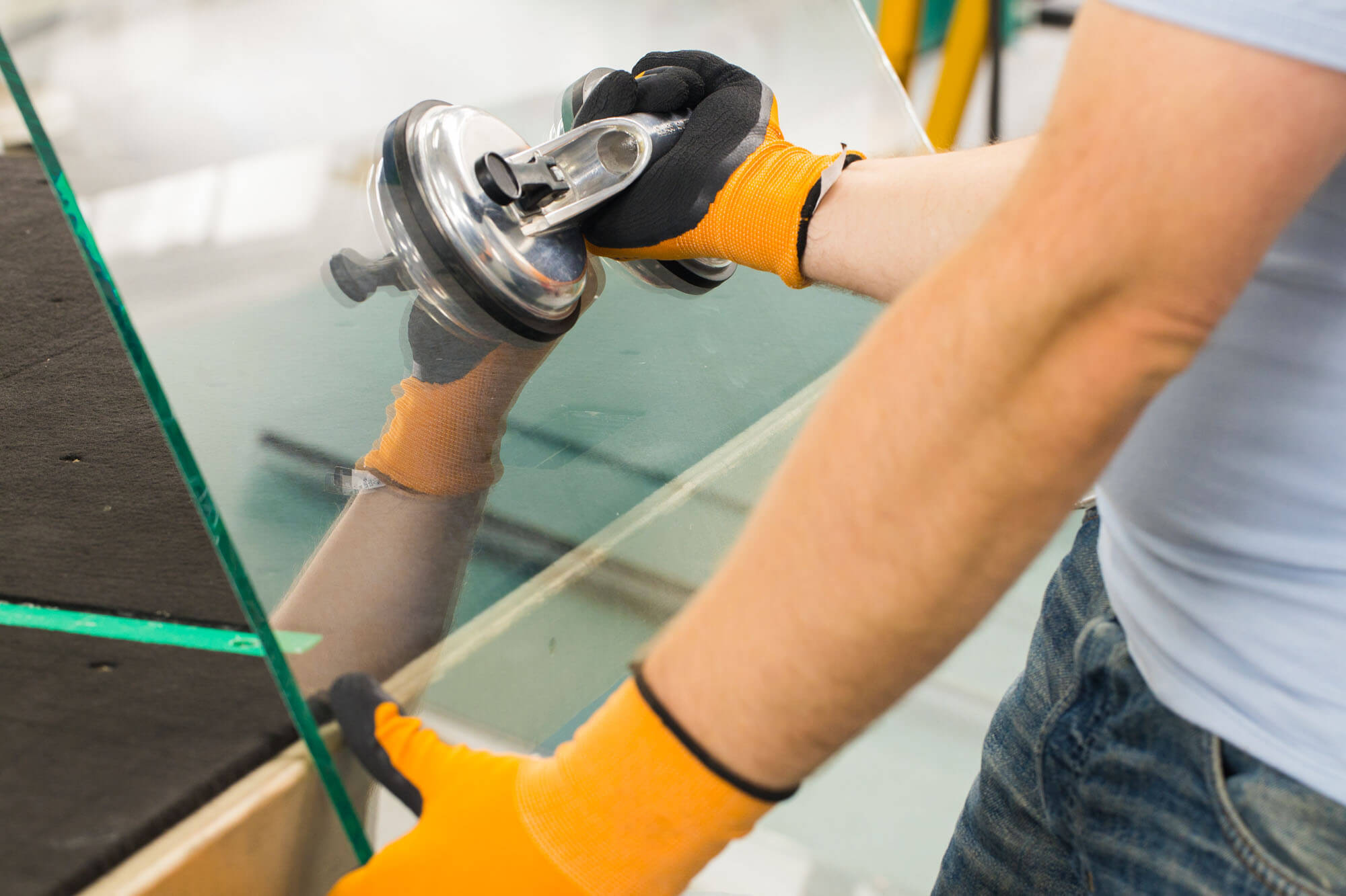 Contractor handling a large pane of glass.